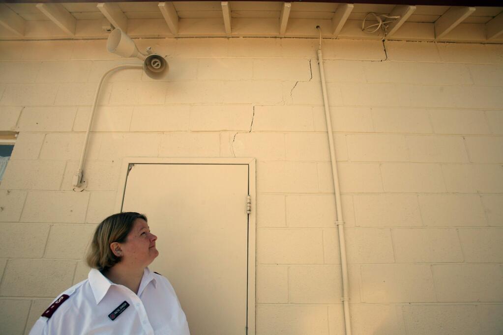Rachael Johnson, Salvation Army Captain, looks at a crack, caused by the Napa earthquake, in a wall of their church building at the Salvation Army on South McDowell Blvd. in Petaluma on Tuesday August 26, 2014. (SCOTT MANCHESTER/ARGUS-COURIER STAFF)