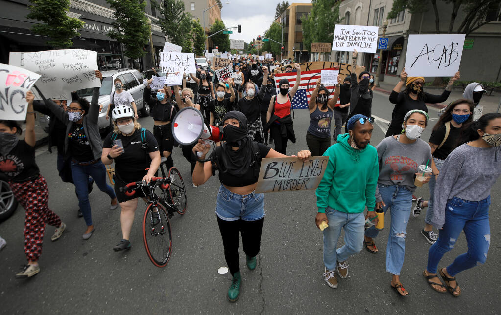 A large group of demonstrators walk north on Mendocino Ave., Saturday, May 30, 2020 in Santa Rosa,  as they protest the death of George Floyd in Minneapolis in which police officer has been charged with the third degree murder in the case.  (Kent Porter / The Press Democrat) 2020