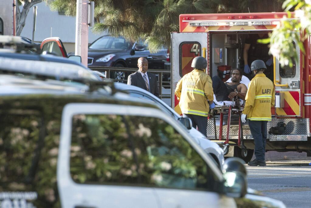 In this photo provided by Christian Monterrosa, a suspect is arrested after evading police and holding dozens of people hostage inside a Trader Joe's supermarket, Saturday, July 21, 2018, in Los Angeles. (Christian Monterrosa via AP)