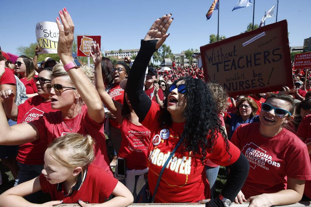 Teachers chant during continued protests at the Arizona Capitol Thursday, May 3, 2018, in Phoenix. After an all night legislative budget session the legislature passed the new education spending portion of the budget and Republican Gov. Doug Ducey signed that part of the budget. (AP Photo/Ross D. Franklin)