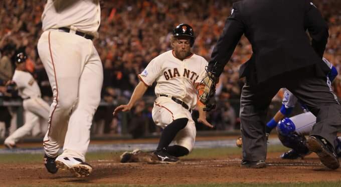 Hunter Pence slides safely into home after Pablo Sandoval scored on double by Juan Perez in the eighth inning during Game 5 of the World Series in San Francisco on Sunday, Oct. 26, 2014. (KENT PORTER/ PD)