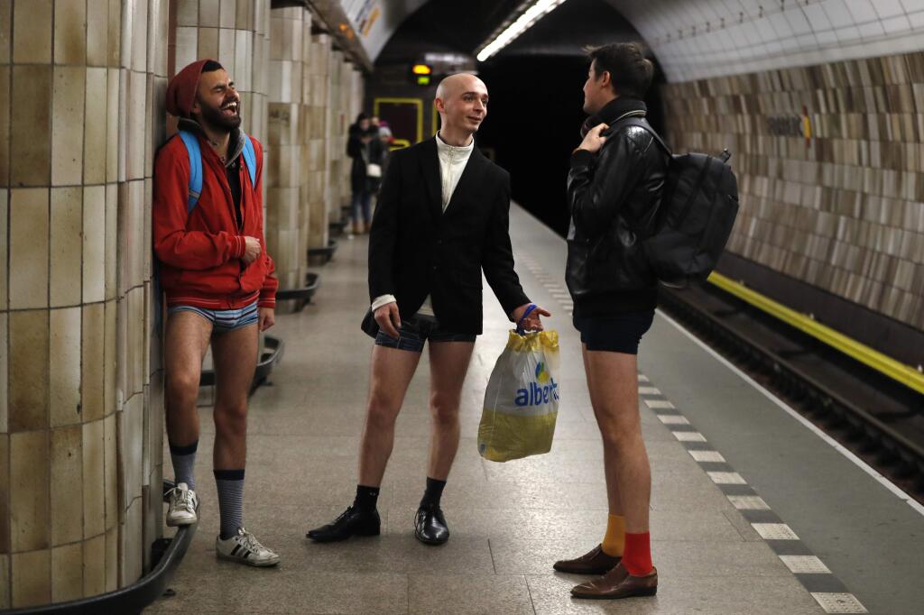 Passengers take part in the No Pants Subway Ride in Prague, Czech Republic, Sunday, Jan. 7, 2018. The No Pants Subway Ride began in 2002 in New York as a stunt and has taken place in cities around the world since then. (AP Photo/Petr David Josek)