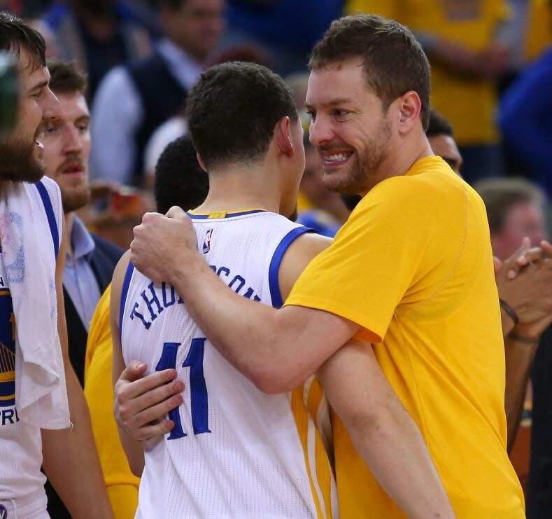 David Lee, right, embraces Warriors teammate Klay Thompson in the closing moments of Game 5 of the Western Conference final at Oracle Arena. (Christopher Chung / The Press Democrat)