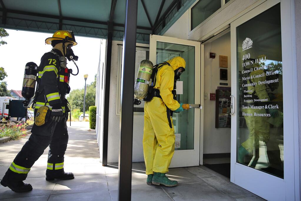 Sonoma County Hazardous Materials Response Unit and Windsor Fire investigate an odor that resulted in the evacuation of the Windsor Town Hall on Tuesday, September 1, 2015. A sweep of the building ruled out the presence of known toxic gases.(Christopher Chung/ The Press Democrat)