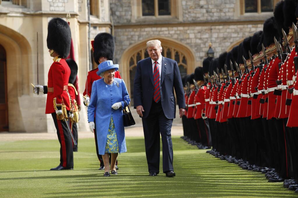 FILE - In this Friday, July 13, 2018 file photo, U.S. President Donald Trump and Queen Elizabeth inspect the Guard of Honour at Windsor Castle in Windsor, England. For Britain's unflappable monarch, the arrival of President Donald Trump, his family and his armored entourage on June 3, 2019 means a full day of ceremony and toasts topped by a magnificent banquet at Buckingham Palace, but beneath the pomp and ceremony there are differences aplenty. The long-delayed state visit, timed to coincide with solemn ceremonies marking the 75th anniversary of the D-Day invasion, has been deeply divisive. (AP Photo/Pablo Martinez Monsivais, file)
