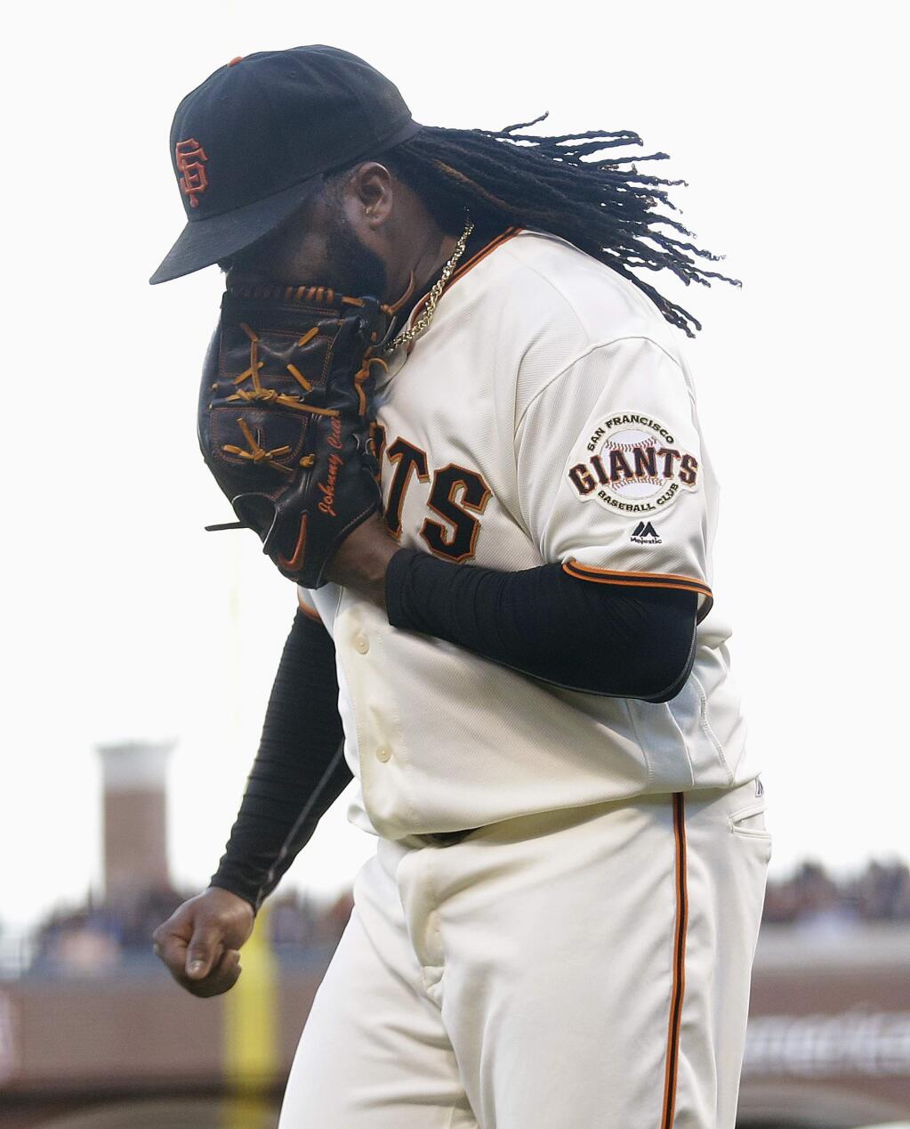 San Francisco Giants pitcher Johnny Cueto yells into his glove after Washington Nationals' Tanner Roark hit an RBI single during the second inning of a baseball game in San Francisco, Thursday, July 28, 2016. (AP Photo/Jeff Chiu)