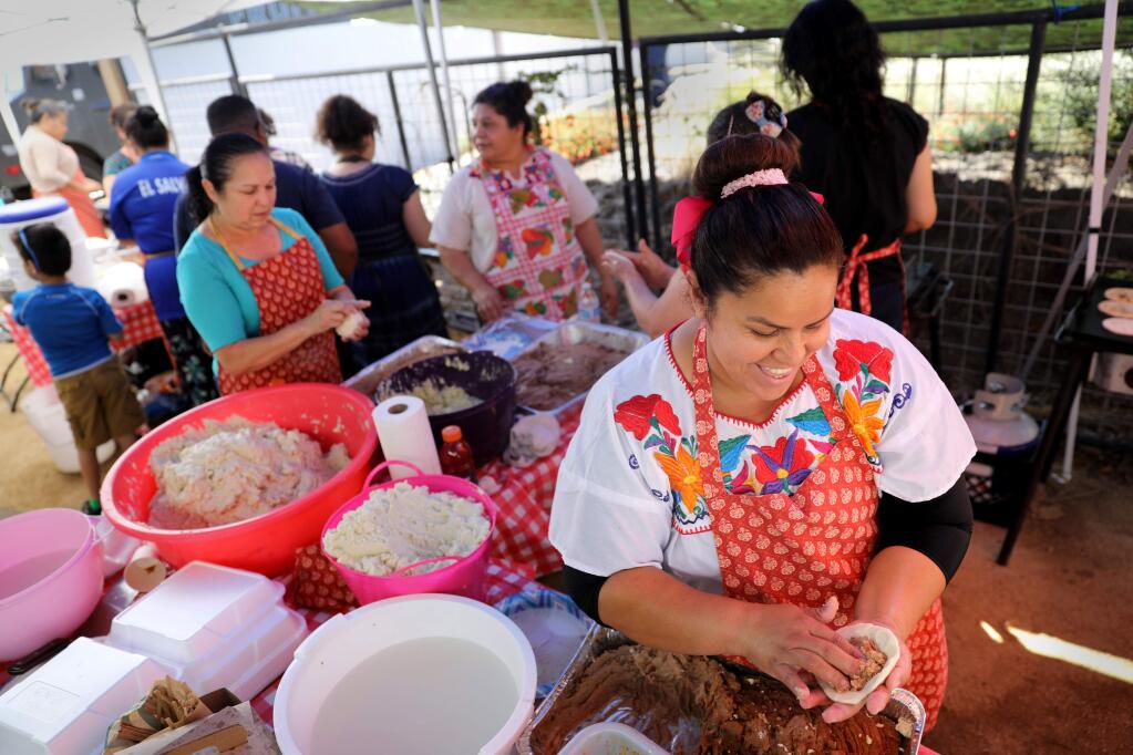Astrid Ruano makes pupusas with a group from New Life Church Santa Rosa during the Fiesta de Independencia at the Luther Burbank Center for the Arts in Santa Rosa on Sunday, September 15, 2019. (BETH SCHLANKER/ The Press Democrat)