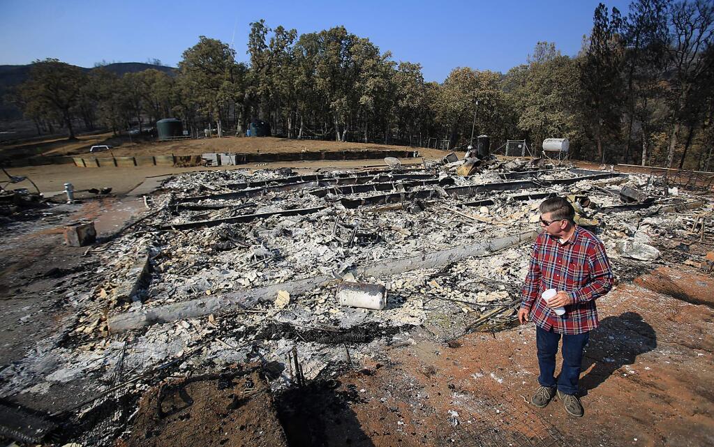 Wayne Fischer returns to his Lake County home for the second time in a week to look for his valuables after the Rocky Fire destroyed his home, Wednesday Aug. 5, 2015. (KENT PORTER/ PD FILE)
