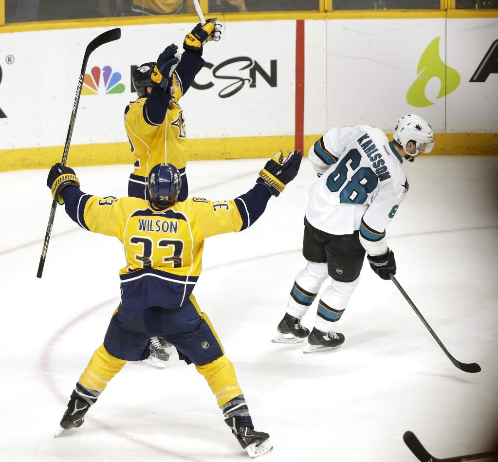 Nashville Predators forward Mike Fisher, top left, and Colin Wilson (33) celebrate as San Jose Sharks center Melker Karlsson (68), of Sweden, skates away after Fisher scored the winning goal during the third overtime period in Game 4 of an NHL hockey Stanley Cup Western Conference semifinal playoff series Friday, May 6, 2016, in Nashville, Tenn. The Predators won 4-3 in triple overtime to even the series 2-2. (AP Photo/Mark Humphrey)