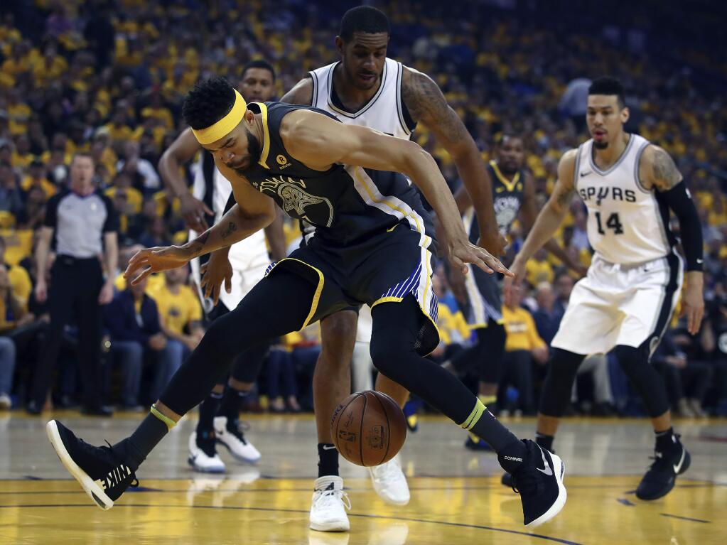 Golden State Warriors' JaVale McGee loses the ball between his legs in front of San Antonio Spurs' LaMarcus Aldridge during the first quarter in Game 2 of a first-round NBA basketball playoff series Monday, April 16, 2018, in Oakland, Calif. (AP Photo/Ben Margot)