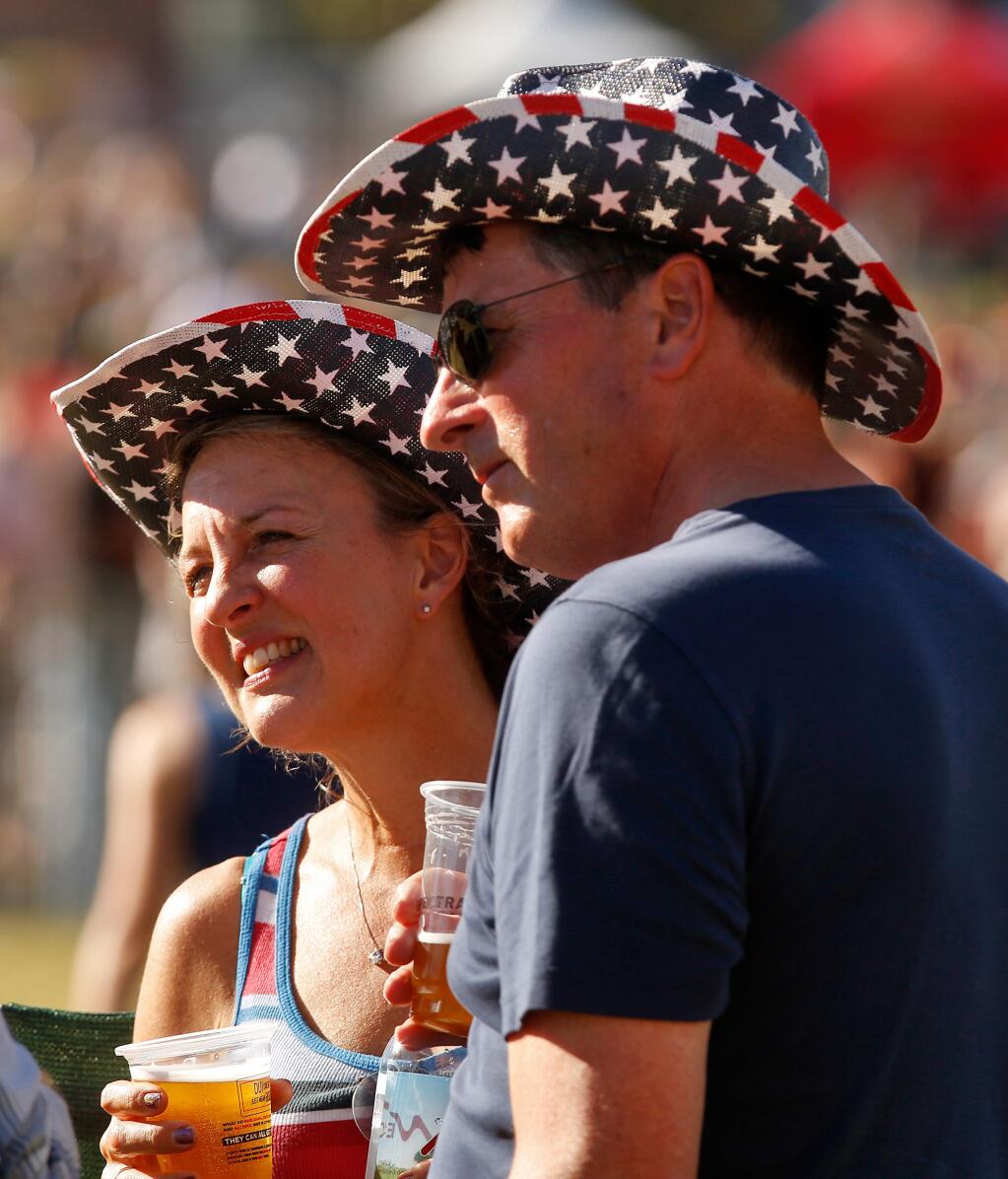 Lauri and John Whims of Seattle display their patriotism in matching stars and stripes cowboy hats at Country Summer at the Sonoma County Fairgrounds in Santa Rosa on Friday, June 16, 2017. (Alvin Jornada / The Press Democrat)
