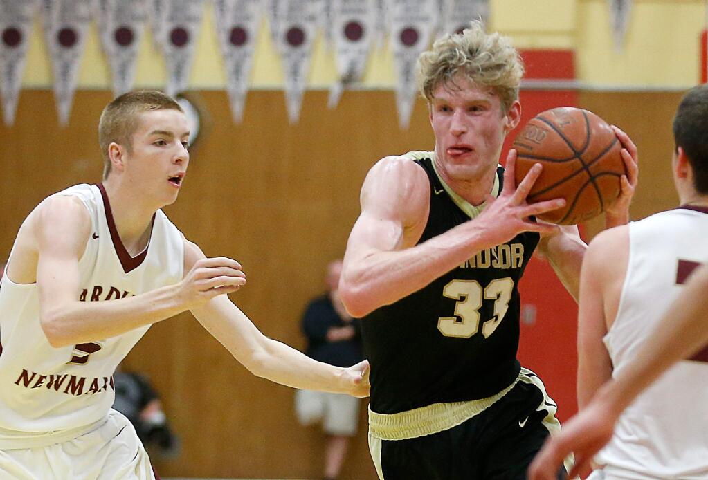 Windsor's Riley Smith (33), center, drives to the basket between Cardinal Newman's Tyler Botteri (5), left, and Brycen Head (21) during the first half of a boys varsity basketball game between Windsor and Cardinal Newman high schools in Santa Rosa, California, on Wednesday, February 7, 2018. (Alvin Jornada / The Press Democrat)