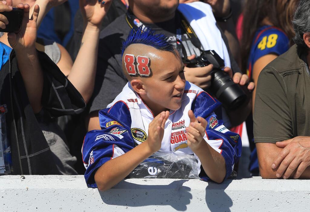 Carson Smith, 13, of San Jose cheers on Dale Earnhardt Jr., during the NASCAR Toyota/Savemart 350, Sunday June 28, 2015 at Sonoma Raceway. (Kent Porter / Press Democrat) 2015