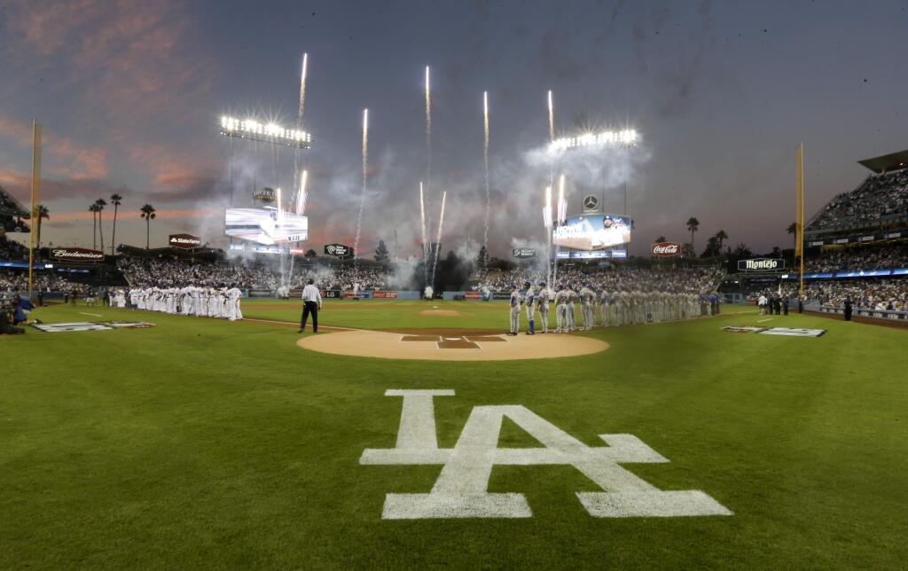 Members of the Los Angeles Dodgers, left, and the New York Mets line up before the start of Game 1 of baseball's National League Division Series, Friday, Oct. 9, 2015 in Los Angeles. (AP Photo/Gregory Bull)