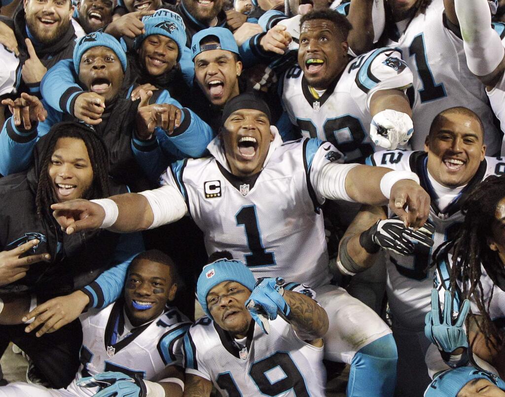 Carolina Panthers' Cam Newton celebrates with teammates during the second half the NFL football NFC Championship game against the Arizona Cardinals Sunday, Jan. 24, 2016, in Charlotte, N.C. (AP Photo/Chuck Burton)