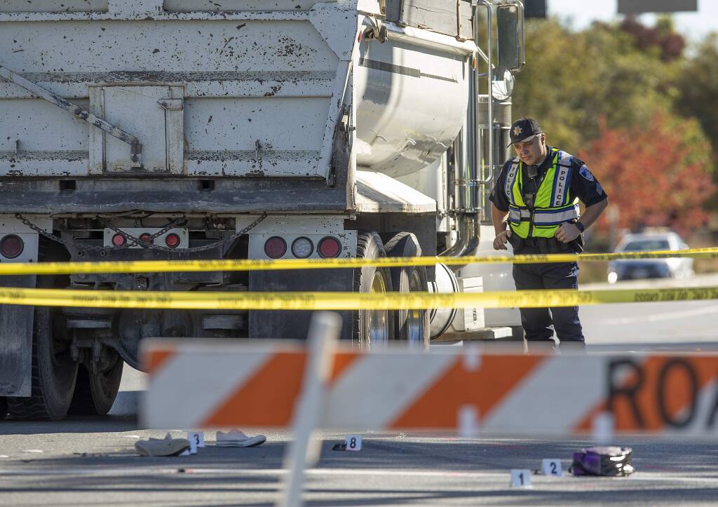 Santa Rosa Police Sgt. Chad Heiser investigates the scene of a fatal bike vs. debris truck accident on Stony Point Road on Tuesday, Oct. 30, 2018. (JOHN BURGESS/ PD)