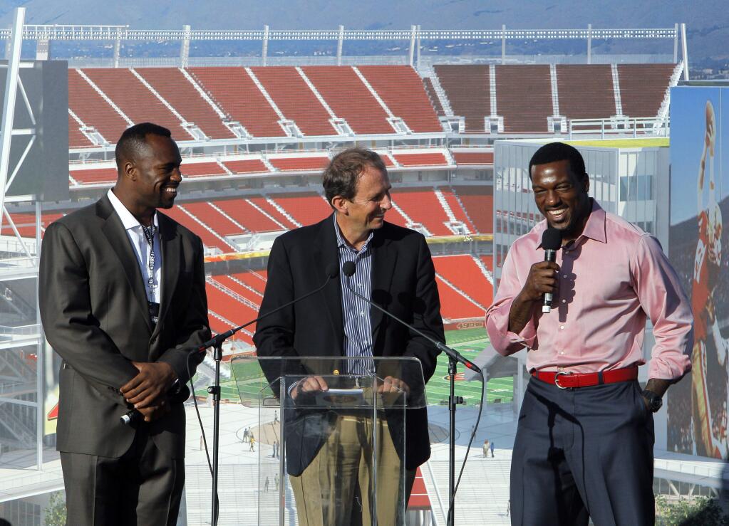 In this April 19, 2012, photo, San Francisco 49ers' Vernon Davis, left, and broadcaster Ted Robinson, center, listen as Patrick Willis addresses the crowd gathered before 49ers ownership and Santa Clara elected officials broke ground on a new stadium for the NFL football team in Santa Clara, Calif. The 49ers suspended veteran broadcaster Robinson on Wednesday night, Sept. 10, 2014, for the next two games following comments this week on a San Francisco radio station about the Ray Rice domestic violence case that were deemed insensitive. The 57-year-old Robinson spoke while co-hosting on KNBR radio Monday and said Rice's now-wife, Janay, was partly to blame for not speaking up. 'That, to me, is the saddest part of it,' he said. (AP Photo/San Francisco Chronicle, Carlos Availa Gonzalez)