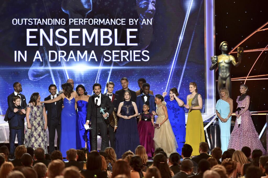 The cast of 'This Is Us' accepts the award for outstanding performance by an ensemble in a drama series at the 24th annual Screen Actors Guild Awards at the Shrine Auditorium & Expo Hall on Sunday, Jan. 21, 2018, in Los Angeles. Goldie Hawn and Kate Hudson look on from right. (Photo by Vince Bucci/Invision/AP)