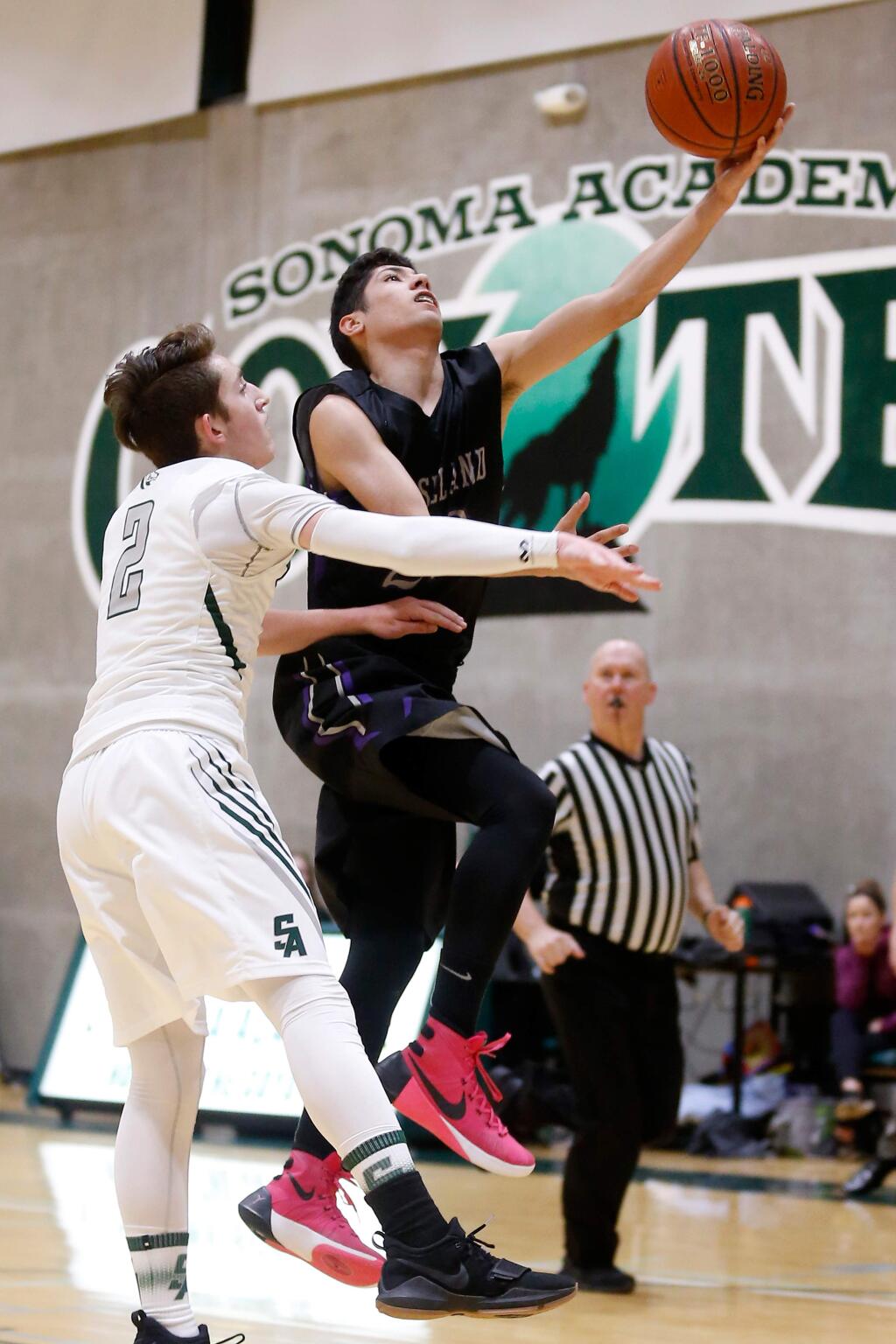 Roseland University Prep's Gilbert Jimenez (22), right, makes a layup while Sonoma Academy's Marco Della Santina (2) defends, during the first half of a boys varsity basketball game between Roseland University Prep and Sonoma Academy in Santa Rosa, California, on Tuesday, January 23, 2018. (Alvin Jornada / The Press Democrat)