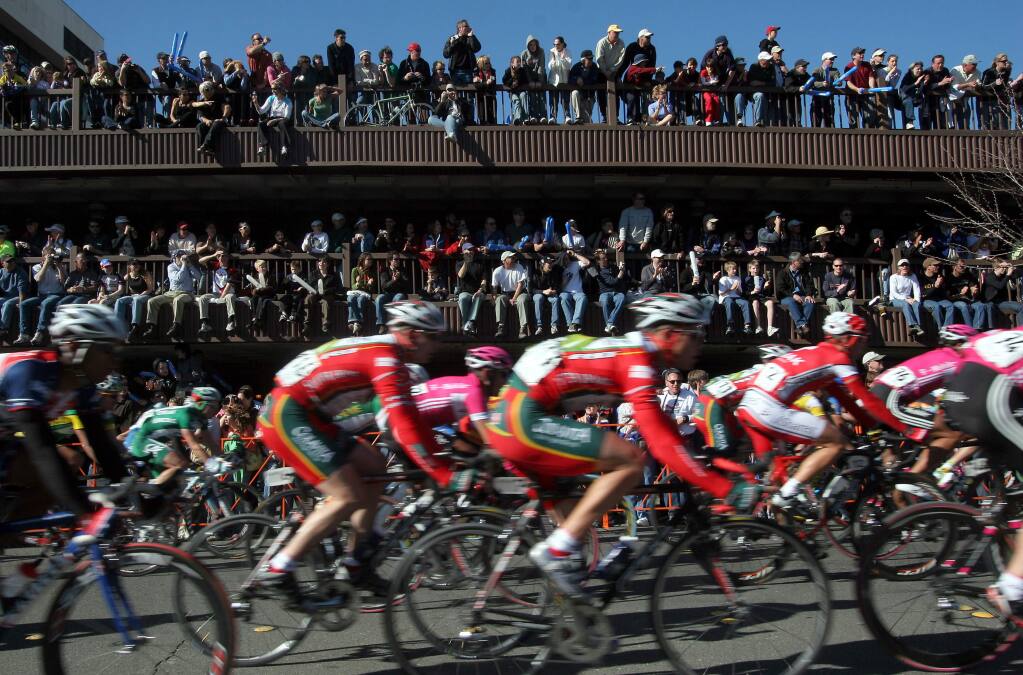 The peloton is a blur as it passes in front of a fan-packed parking garage on Third Street in downtown Santa Rosa in February 2006.