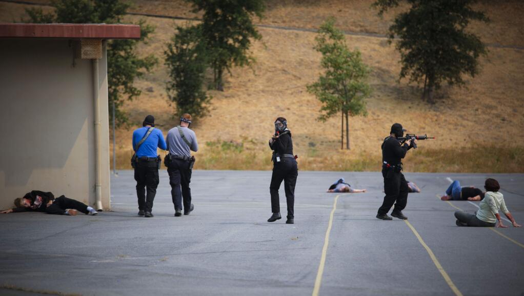 The Petaluma Police Department and Petaluma Fire Department conducted joint tactical scenario training on the Petaluma Junior High School campus. Using volunteers to role-play, the scenarios involved and active shooter on campus and a knife attack.(CRISTINA PASCUAL/ARGUS-COURIER STAFF)