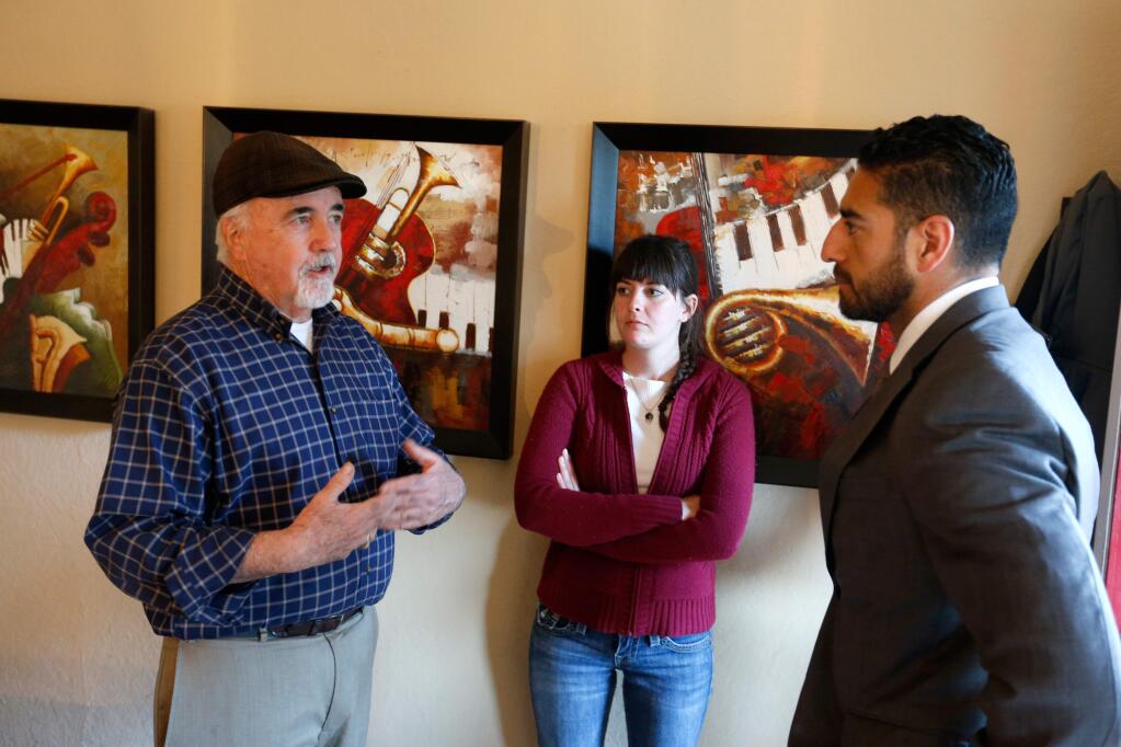 Evicted tenants Dennis McGovern, left, and Samantha Stephey talk with Sonoma County supervisor Efren Carrillo before a meeting with him and a representative from Legal Aid of Sonoma County about their evictions from a group of rental houses in Santa Rosa, California on Thursday, April 14, 2016. (Alvin Jornada / The Press Democrat)