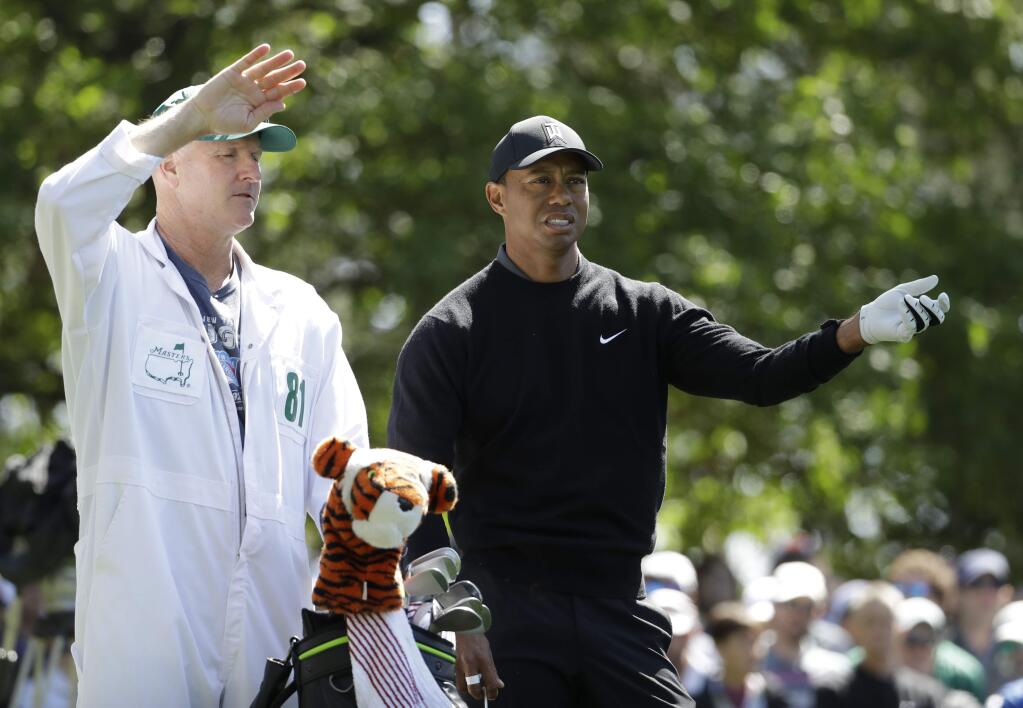 Tiger Woods looks over a shot on the fourth hole during the first round at the Masters golf tournament Thursday, April 5, 2018, in Augusta, Ga. (AP Photo/Matt Slocum)