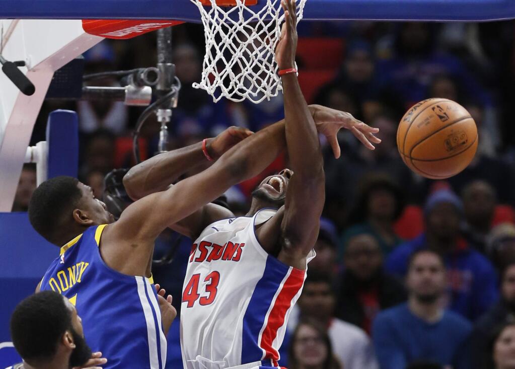 Golden State Warriors forward Kevon Looney, left, blocks a shot by Detroit Pistons forward Anthony Tolliver during the second quarter Friday, Dec. 8, 2017, in Detroit. (AP Photo/Duane Burleson)