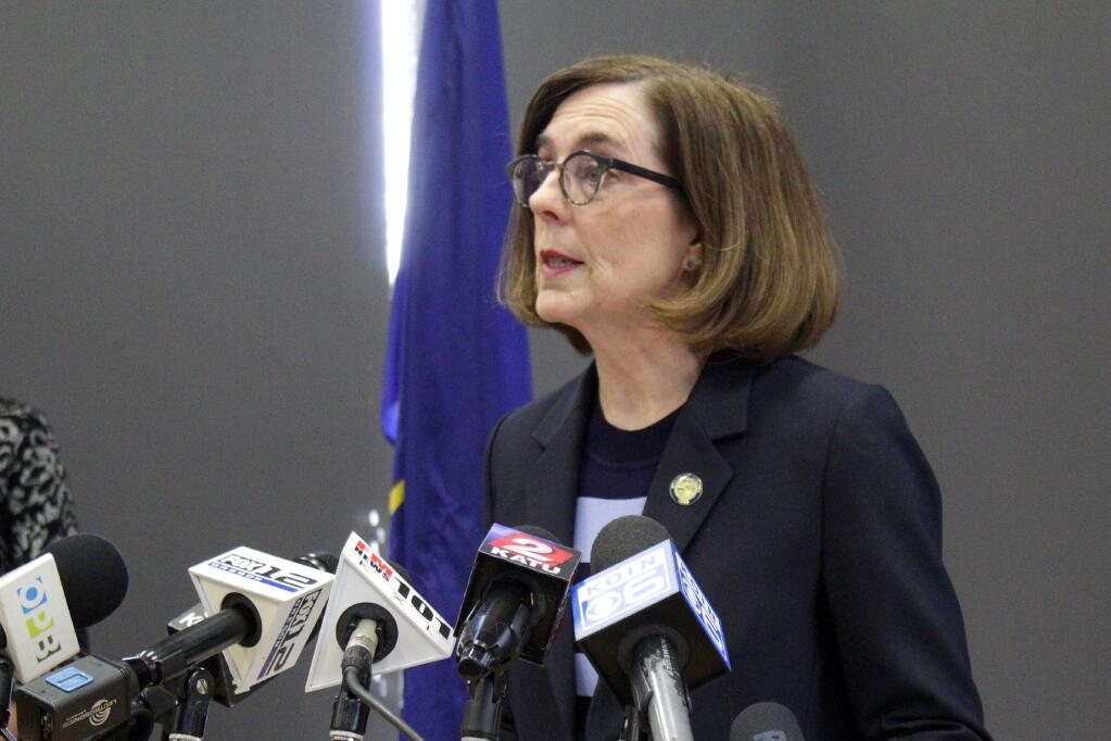 FILE - In this March 16, 2020, file photo, Oregon Gov. Kate Brown speaks at a news conference in Portland, Ore. A county judge has declared Brown's coronavirus restrictions 'null and void' because she didn't have her emergency orders approved by the Legislature. Baker County Circuit Judge Matthew Shirtcliff made the ruling Monday, May 18, 2020, in a lawsuit brought by churches that had sued saying the social-distancing directives were unconstitutional.(AP Photo/Gillian Flaccus, File)