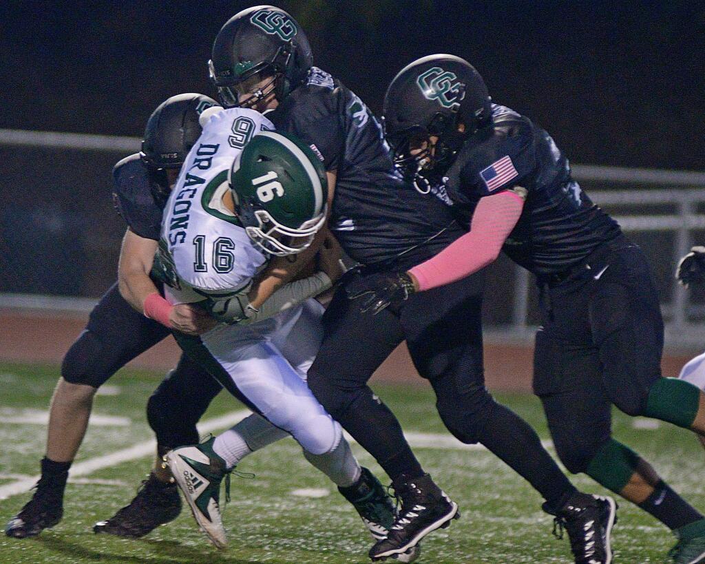 SUMNER FOWLER/FOR THE ARGUS-COURIERThree Casa Grande defenders gang tackle Sonoma Valley ball carrier during Casa's 40-7 victory.