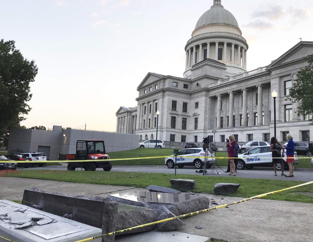 The new Ten Commandments monument outside the state Capitol in Little Rock, Ark., is blocked off Wednesday morning, June 28, 2017, after someone crashed into it with a vehicle, less than 24 hours after the privately funded monument was placed on the Capitol grounds. Authorities arrested a male suspect. (AP Photo/Jill Zeman Bleed)