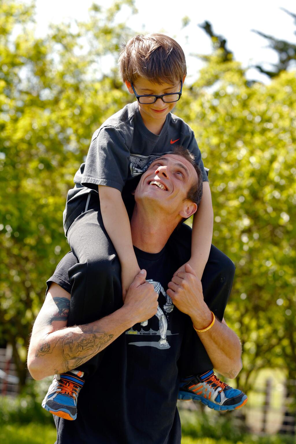 Eddie Zentner carries his son Jayden, 7, at their family farm in Petaluma, California on Saturday, April 23, 2016. Zenter is raising funds and awareness for the Leukemia and Lymphoma Society to honor Jayden who was diagnosed with leukemia at age 4 but is currently in remission. (Alvin Jornada / The Press Democrat)
