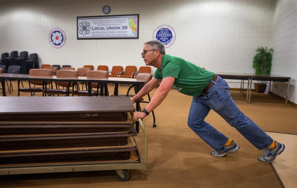 Jack Buckhorn, Executive Director of the North Bay Labor Council, returns tables and chairs to the local union hall after the election. Buckhorn was opposed to Measure N, saying it didn't offer enough protection for workers who would build new units. (photo by John Burgess/The Press Democrat)