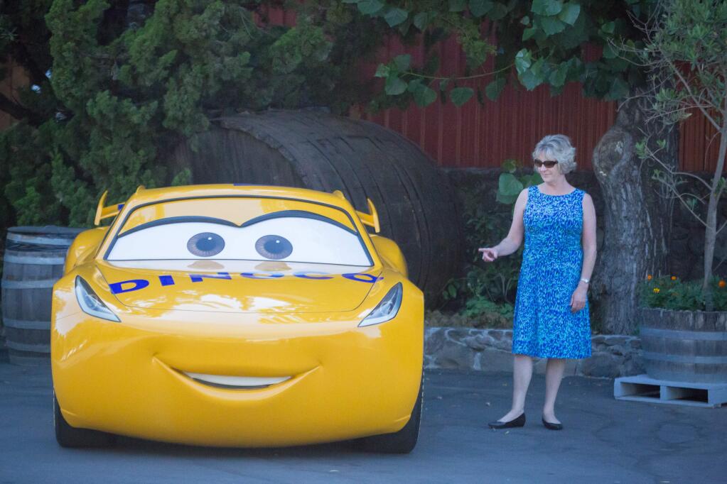 Debbie Thornton, of United Site Services, checks out one of the cars from Cars 3 Friday June 23, 2017, during The Children's Champion NASCAR Grand Marshal Banquet at Cline Cellars in Sonoma, Calif. The event was a fundraiser for the Sonoma Chapter of Speedway Children's Charities.(Jeremy Portje / For The Press Democrat)