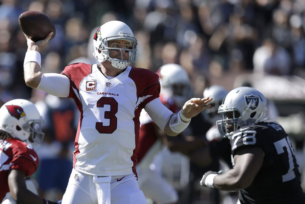 Arizona Cardinals quarterback Carson Palmer (3) passes against the Oakland Raiders during the first quarter of an NFL football game in Oakland, Calif., Sunday, Oct. 19, 2014. (AP Photo/Ben Margot)
