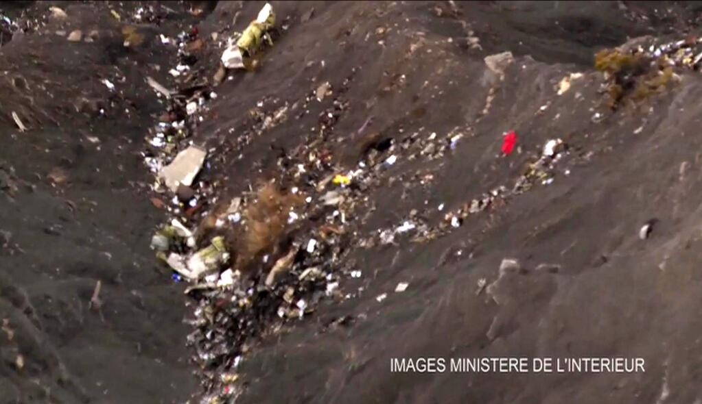 In this still image taken from video provided by the French Interior Ministry on Wednesday, March 25, 2015, wreckage from the crashed Germanwings flight is seen in the Southern French Alps. A black box recovered from the scene and pulverized pieces of debris strewn across Alpine mountainsides held clues to what caused a German jetliner to take an unexplained eight-minute dive Tuesday midway through a flight from Spain to Germany, apparently killing all 150 people on board. (AP Photo via French Interior Ministry)