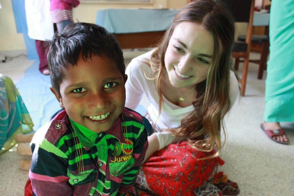 Santa Rosa resident Ashlee Ruggels, 16, with a child she met March 17 while on a medical aid trip in Kathmandu, Nepal. (Courtesy photo)