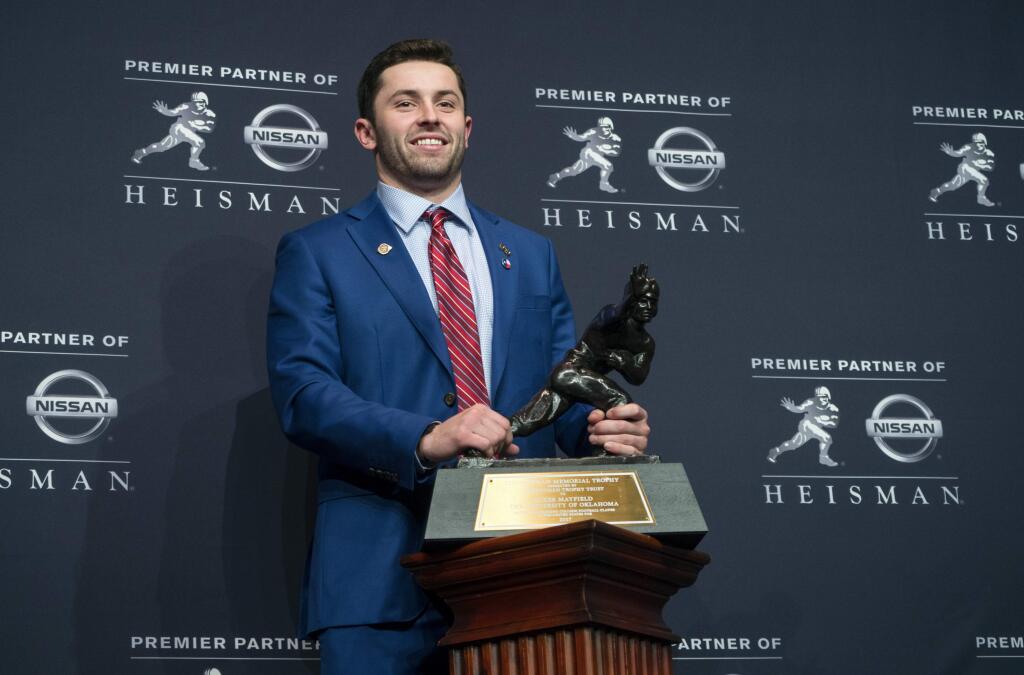 Oklahoma quarterback Baker Mayfield, winner of the Heisman Trophy, poses with the award Saturday, Dec. 9, 2017, in New York. (AP Photo/Craig Ruttle)