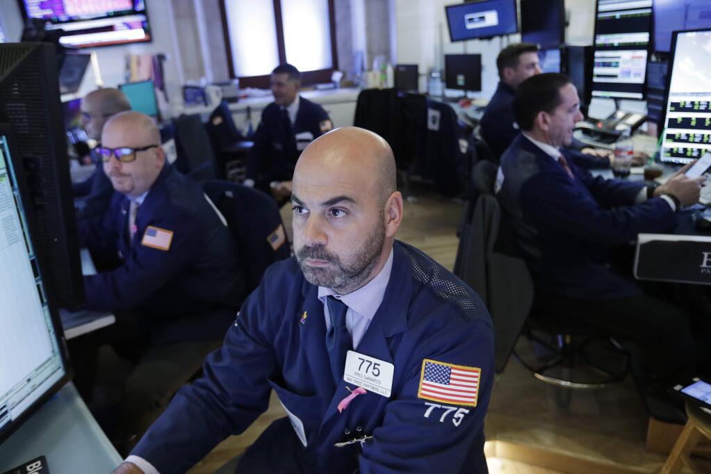Trader Fred DeMarco follows stock activity, Monday, Nov. 19, 2018, at the New York Stock Exchange. Big technology and internet companies came under heavy selling pressure again on Monday, leading to broad losses across the stock market. The Dow Jones Industrial Average briefly fell 500 points. (AP Photo/Mark Lennihan)