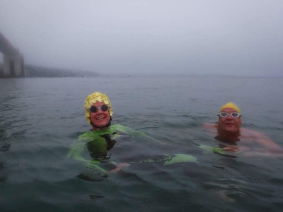 SUBMITTED PHOTOPetaluman Kathie Hewko, in her new lime-green wet suiit, is joined by friend and fellow Golden Gate Bridge swimmer Dusty Nicol in her 93rd successful swim of the length of the Bridge.