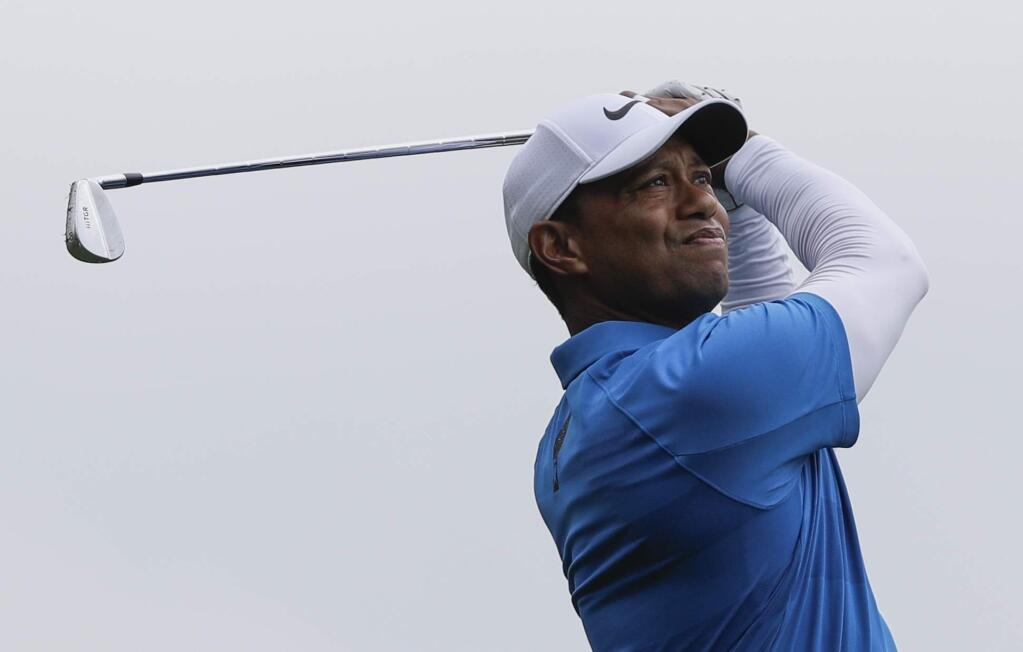 Tiger Woods watches his shot on the fourth hole during the third round at the Masters golf tournament Saturday, April 7, 2018, in Augusta, Ga. (AP Photo/David J. Phillip)
