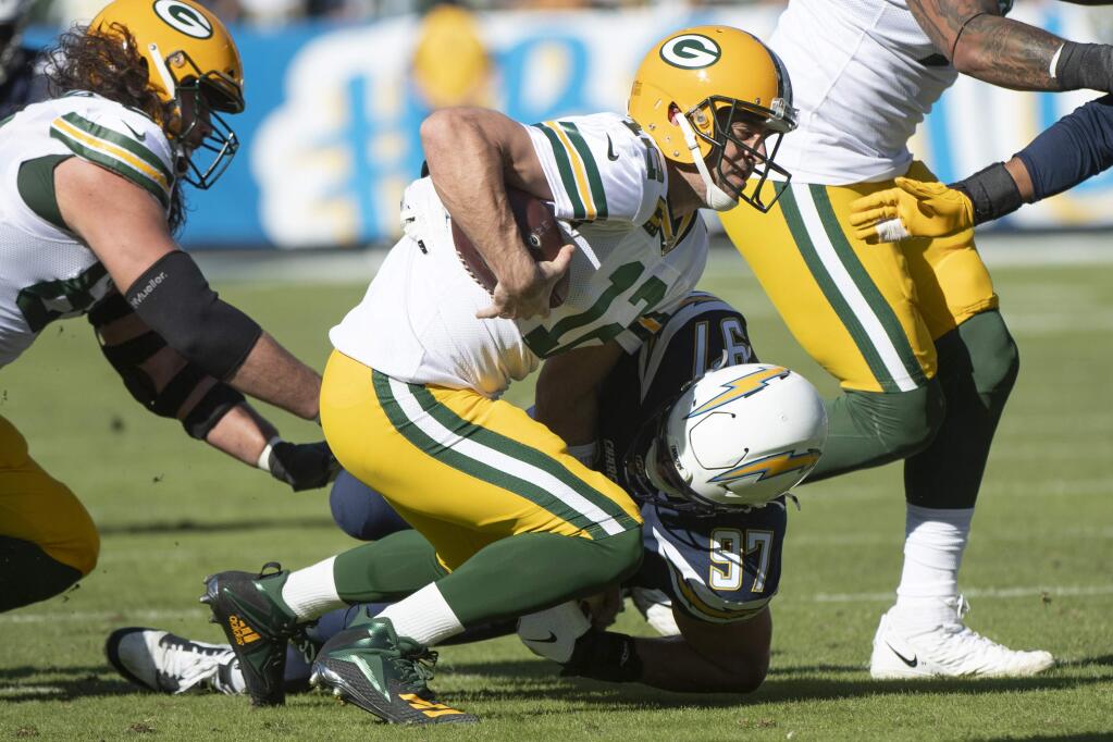 Los Angeles Chargers defensive end Joey Bosa, back, sacks Green Bay Packers quarterback Aaron Rodgers Sunday, Nov. 3 2019 in Carson. (AP Photo/Kyusung Gong)