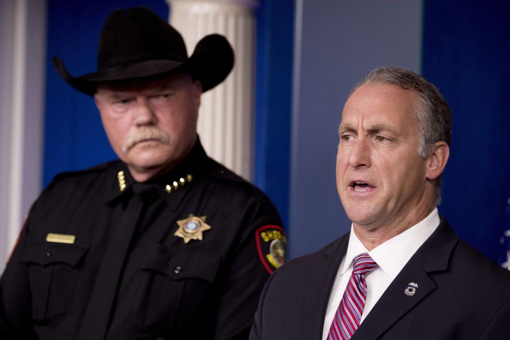 Immigration and Customs Enforcement Director Matt Albence, right, accompanied by sheriffs from around the country including Tarrant County, Texas Sheriff Bill Waybourn, left, speaks in the Briefing Room at the White House in Washington, Thursday, Oct. 10, 2019. (AP Photo/Andrew Harnik)