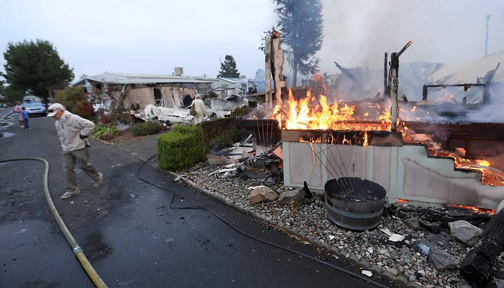 Mobile homes burn Sunday Aug. 24, 2014 in Napa following a 6.0 earthquake that centered in American Canyon. (Kent Porter / Press Democrat) 2014