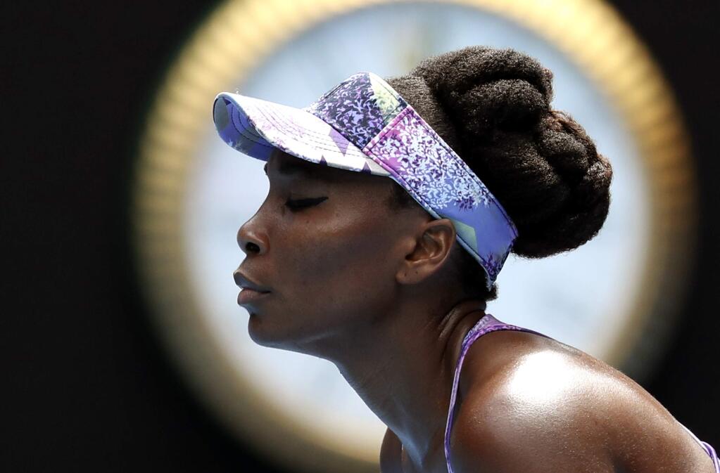 United States' Venus Williams pauses while playing compatriot Coco Vandeweghe during their semifinal at the Australian Open tennis championships in Melbourne, Australia, Thursday, Jan. 26, 2017. (AP Photo/Aaron Favila)