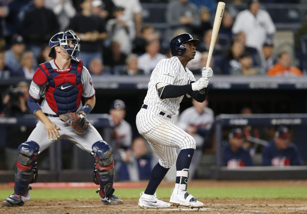 Minnesota Twins catcher Jason Castro and the New York Yankees' Didi Gregorius watch Gregorius' first-inning, three-run home run in the American League wild-card game in New York, Tuesday, Oct. 3, 2017. (AP Photo/Kathy Willens)