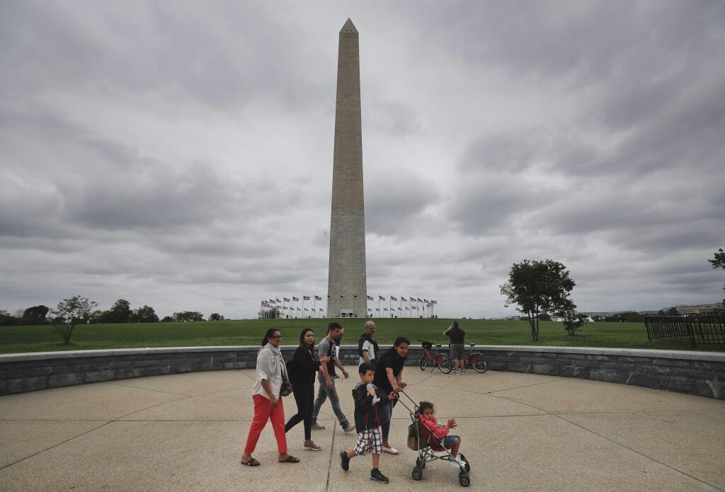 Visitors walks past the Washington Monument on the National Mall in Washington, Monday, Sept. 26, 2016. Elevator trouble closes Washington Monument indefinitely the National Park Service says the Washington Monument will be closed indefinitely because of ongoing problems with its elevator. The park service said in a statement Monday that the monument will remain closed until its elevator control system can be modernized. The lone elevator that takes visitors to the top of the 555-foot obelisk has broken down frequently over the past two years. (AP Photo/Pablo Martinez Monsivais)