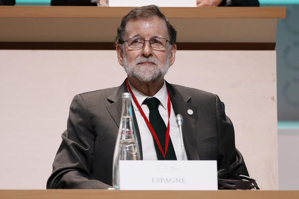 Spanish Prime Minister Mariano Rajoy attends the plenary session of One Planet Summit, in Boulogne-Billancourt near Paris, France, Tuesday, Dec. 12, 2017. World leaders, investment funds and energy magnates promised to devote new money and technology to slow global warming at a summit in Paris that President Emmanuel Macron hopes will rev up the Paris climate accord that U.S. President Donald Trump has rejected. (Etienne Laurent/Pool Photo via AP)