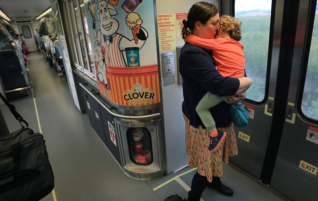 Elizabeth Boyle of Petaluma takes a moment with her son Liam Philpot, 3, Friday August 17, 2018. Boyle uses SMART to commute to work in Marin County and drop her son with a baby sitter a stop before hers. (Kent Porter / The Press Democrat) 2018