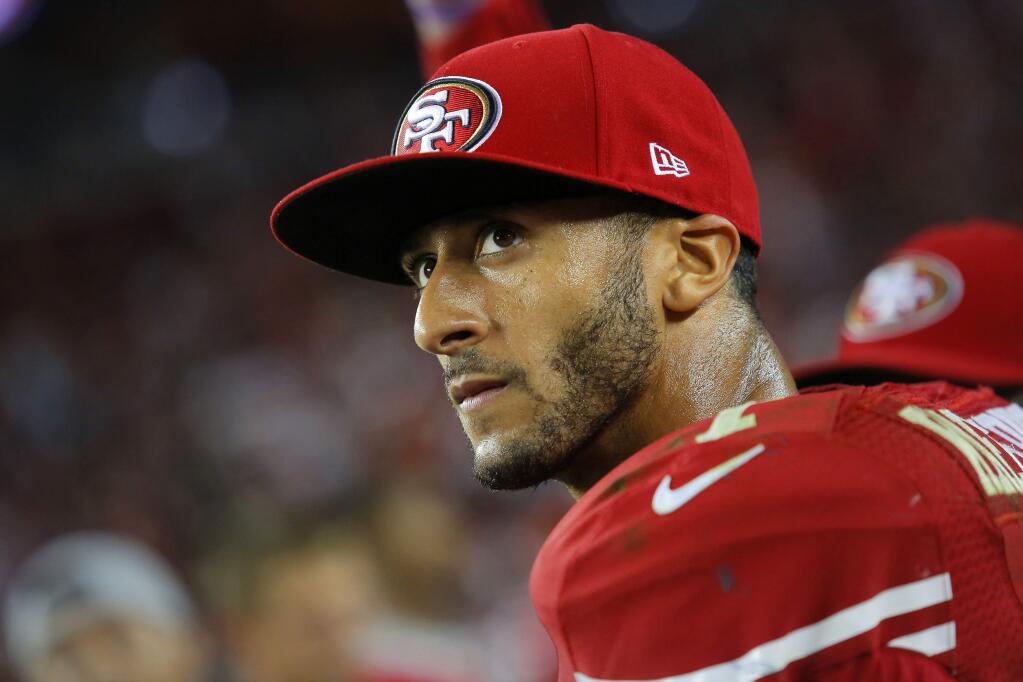 Colin Kaepernick looks up at the final score after losing to the Chicago Bears during the season opener at the new Levi's Stadium in Santa Clara on Sunday, September 14, 2014. (Conner Jay/Press Democrat)